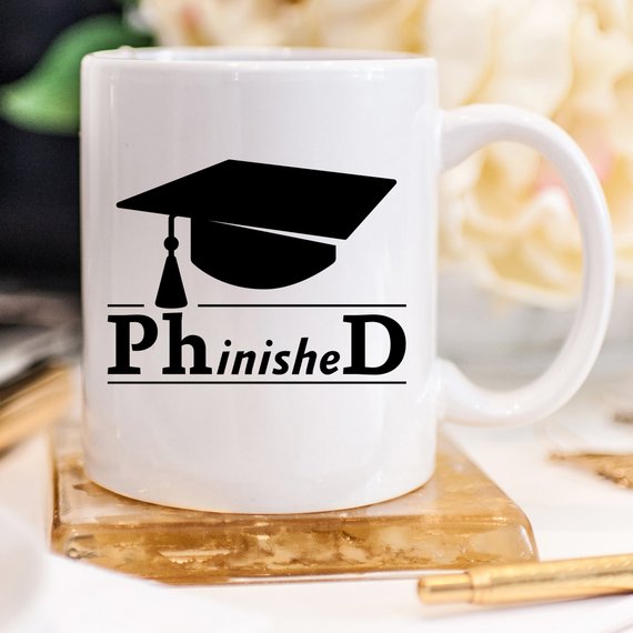 PhinisheD 11oz Coffee Mug featuring a humorous design, perfect for coffee lovers and graduates.